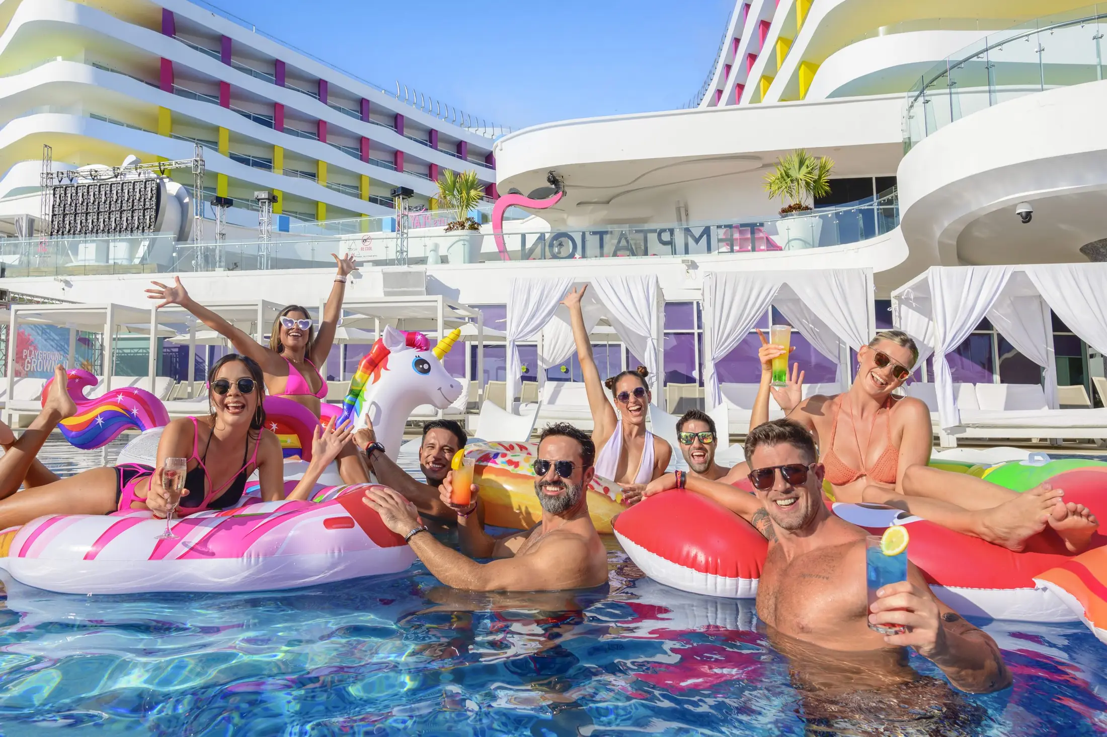 Guests enjoying a colorful pool party at Temptation Cancun Resort